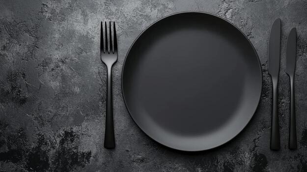 Monochrome Cutlery Set On Dark Textured Surface photo