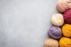 Colorful Yarn Balls Arranged Against Soft Gray Background photo