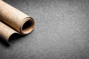 Rolled Paper on a Textured Gray Surface photo