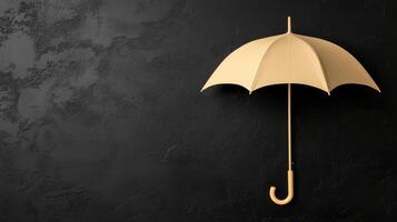 A Yellow Umbrella Against a Dark Rough Wall photo