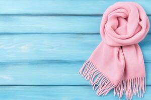 Pink Scarf on a Light Blue Wooden Surface photo