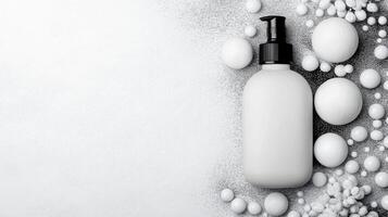 Top view of plain lotion container among scattered round elements photo