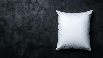 White Pillow on Dark Textured Background Top Down View photo