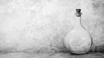 Empty Glass Bottle on Textured Gray Surface photo