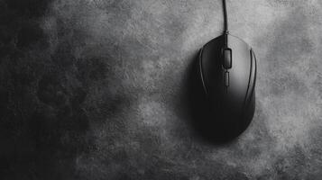 Black Computer Mouse with Cord on Textured Surface photo