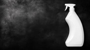 White Spray Bottle Contrasted Against Dark Textured Background photo