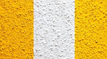 Textured Yellow and White Painted Wall Surface photo