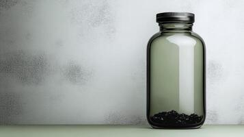 Gray Glass Bottle with Black Cap and Contents photo