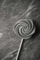 Gray Rose Lollipop on a Marble Surface photo