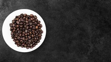 Coffee Beans on a White Plate on a Black Background photo