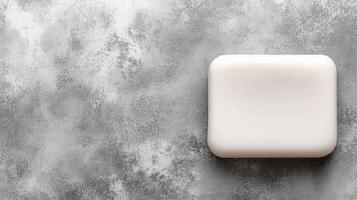 White Bar of Soap on a Textured Gray Background photo