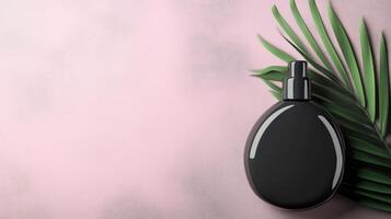 Black Glossy Bottle on a Pink Background photo