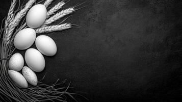 Still life with eggs and spotted stones decorated with wheat on the table photo