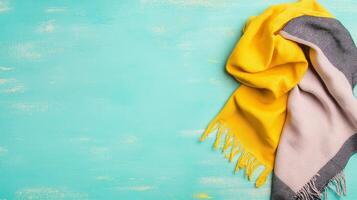 Yellow Scarf on a Teal Wooden Surface photo