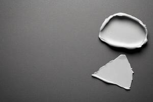 White Cream Swatches on a Dark Gray Surface photo
