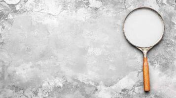 Wooden Handled Racket on a Gray Surface photo