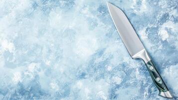 Silver Knife on a Blue Textured Background photo