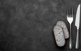 Dark Table Setting with Bread and Silverware photo