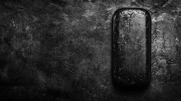 Black Rounded Object on a Dark Rough Surface photo