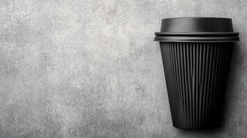Black Coffee Cup on a Gray Textured Background photo