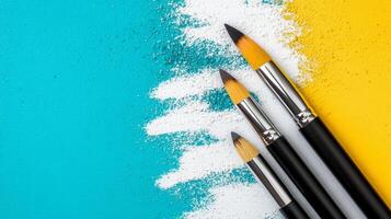 Paintbrushes on a Colorful Textured Surface photo
