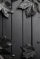Black Leaves on a Dark Wooden Surface photo