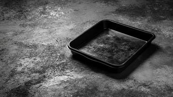 Black Baking Pan on a Gray Textured Surface photo
