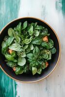 Spinach and Basil Salad in a Black Bowl photo