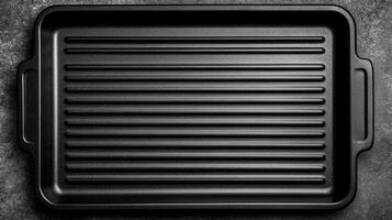 Black Grill Pan on a Dark Gray Textured Surface photo