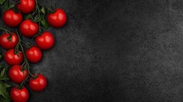 Red Cherry Tomatoes on a Black Textured Background photo
