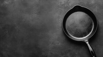 Black Cast Iron Skillet on a Black Textured Background photo