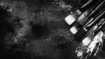 Arrangement of Paintbrushes on Dark Textured Surface photo