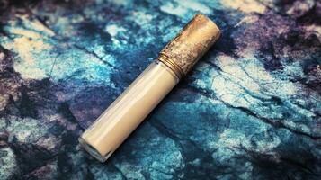 Luminous Concealer Tube on an Abstract Textured Surface photo