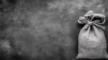 Monochrome Burlap Sack with Tied Knot on a Dark Background photo