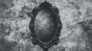 Ornate Black Mirror on a Marbled Gray Background photo