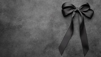 Elegant Black Bow on Textured Dark Gray Background photo