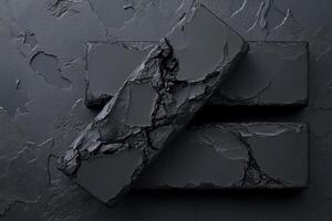 Detailed Black Rectangles with Cracked Texture on Dark Surface photo