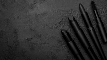 Monochrome Makeup Tools on Textured Dark Surface photo