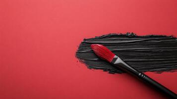 Crimson Surface with Black Paint Stroke and Brush photo
