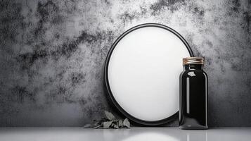 Black Glossy Bottle with Gold Cap Beside a White Round Mirror photo