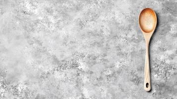 Wooden Spoon on Textured Stone Surface, Top View Layout photo