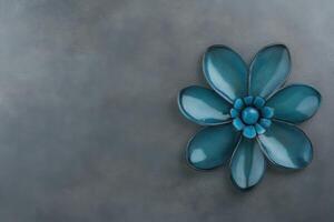 Blue Ceramic Flower on Textured Gray Surface, Flat Lay photo