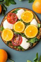 Citrus and Tomato Pizza Slices on Flat Dough, Greens, Top View photo