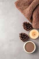 Cozy Spa Arrangement Towel, Cones, Candle, and Bowl on Gray Surface photo