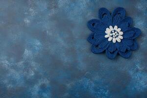 Blue Crocheted Flower on Blue Textured Surface photo