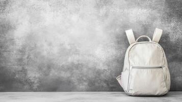 Light Gray Backpack on a Textured Stone Surface with a Smoky Backdrop photo
