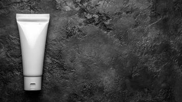White Tube on a Rough Dark Stone Surface in Monochrome photo