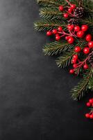 Festive Pine Branches with Red Berries and Cones on Dark Surface photo