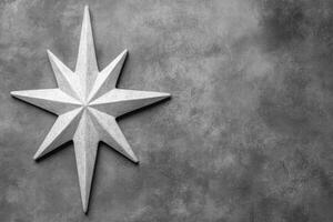 Carved White Star Symbol on a Textured Gray Stone Surface photo