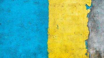 Weathered Wall with Peeling Blue and Yellow Paint Over a Gray Base photo